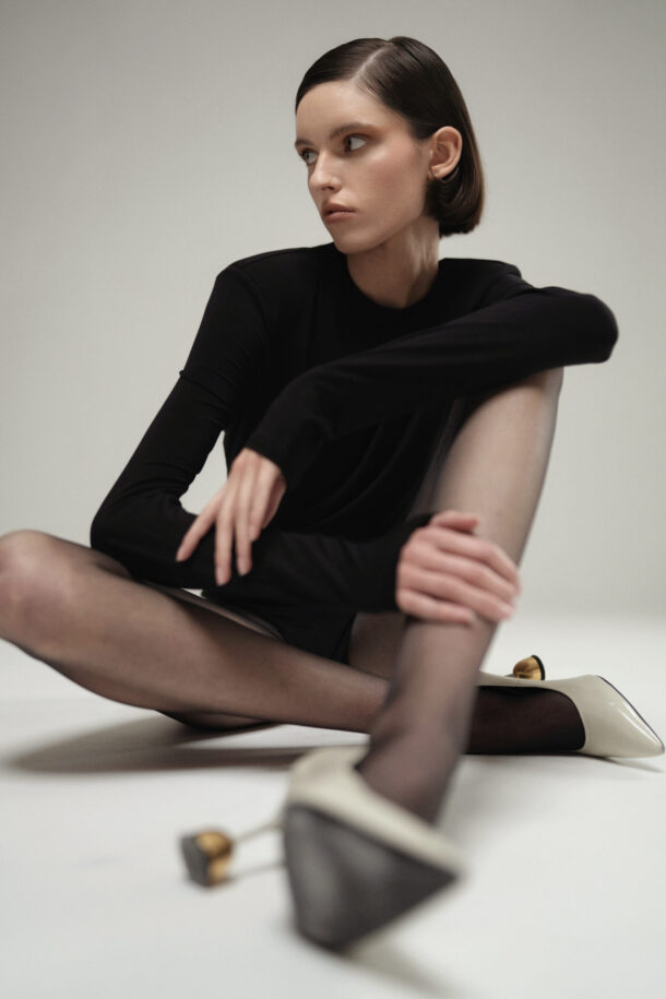 Black long-sleeved bodysuit with shoulder pads